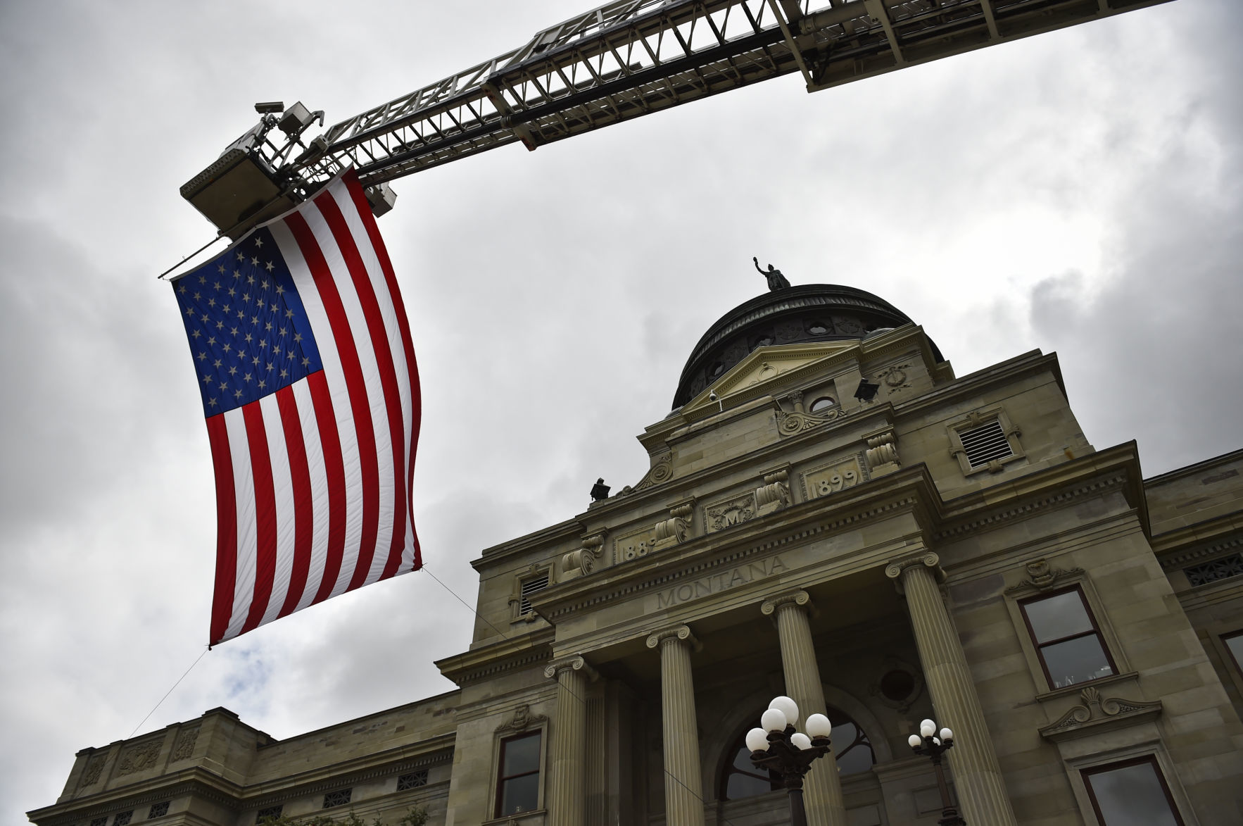 A ladder truck displays an American Flag